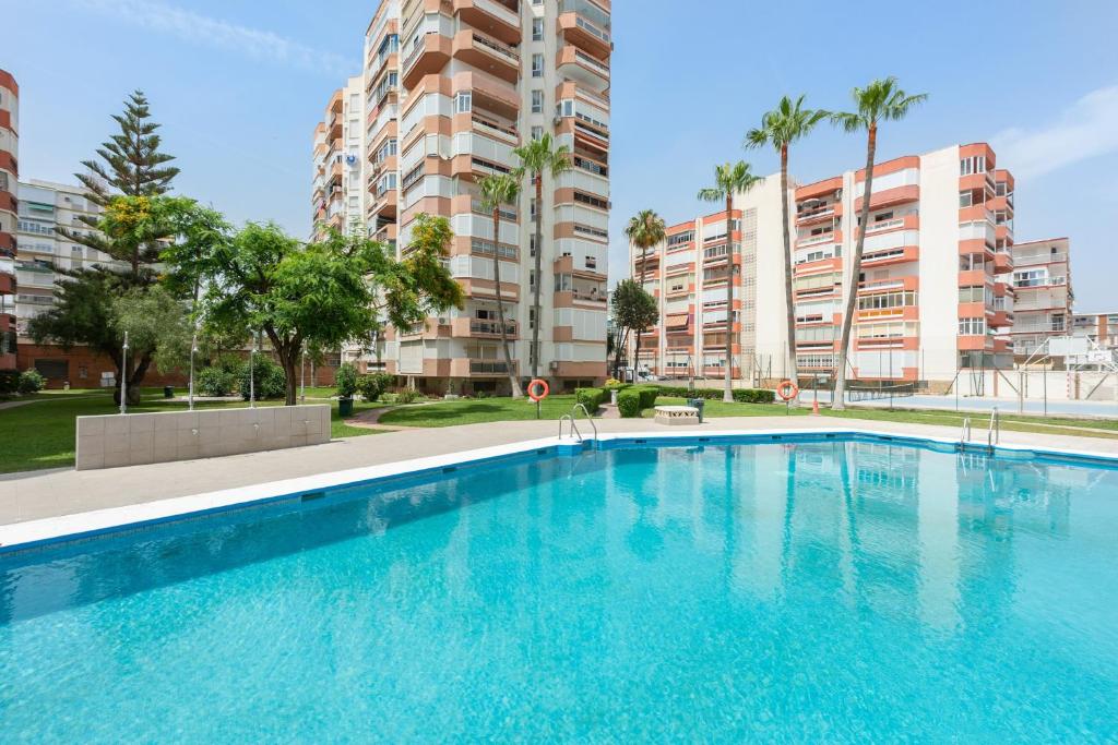 a large swimming pool in front of some tall buildings at Apartamento Lucía in Torre del Mar