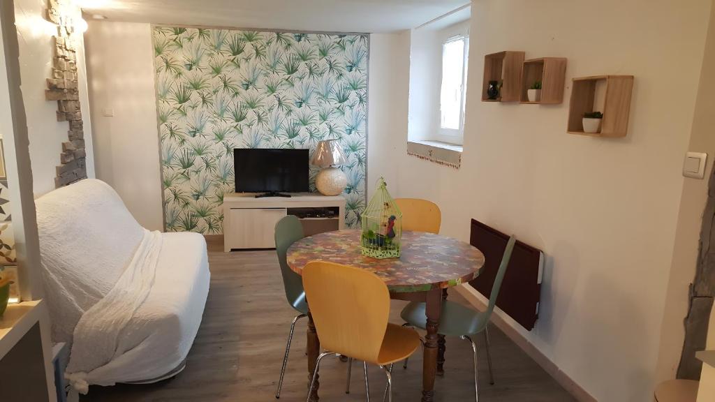 a small dining room with a table and chairs at Gîte Du Vignal in Mazeyrat-d'Allier