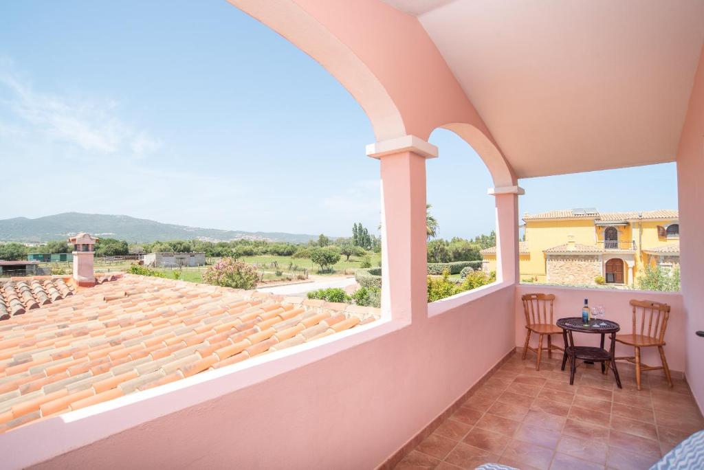 a view from the balcony of a house with a table and chairs at Sardegna Budoni giardino e Jacuzzi in Budoni