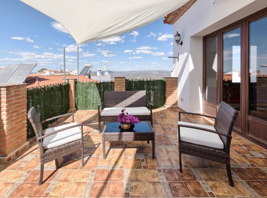 a patio with chairs and a table on a roof at El Paladin in Zufre