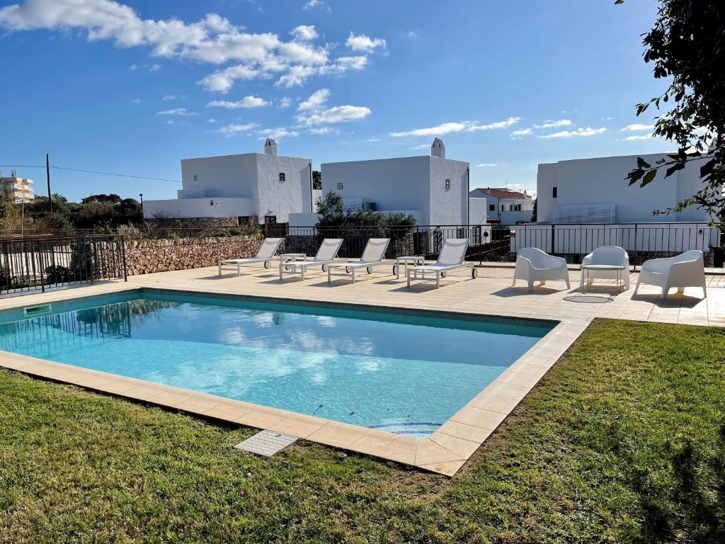 a swimming pool with lounge chairs at Casa da Lúa in Sant Lluis