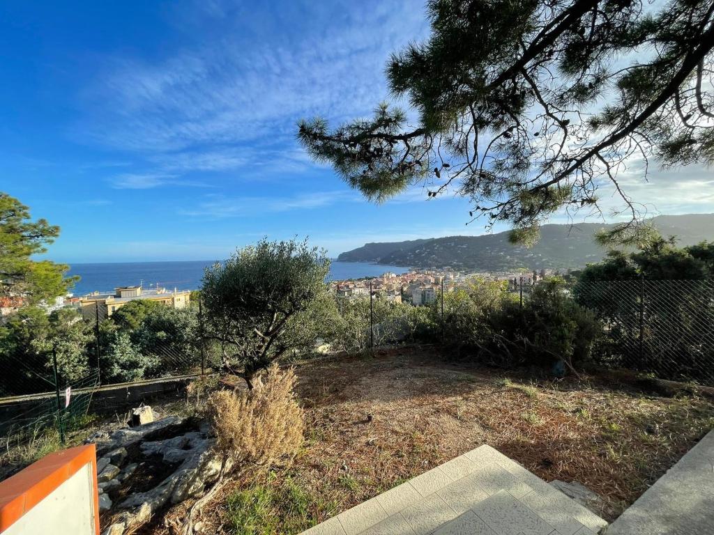 a view of a city and the ocean from a hill at Villetta My Sea in Spotorno