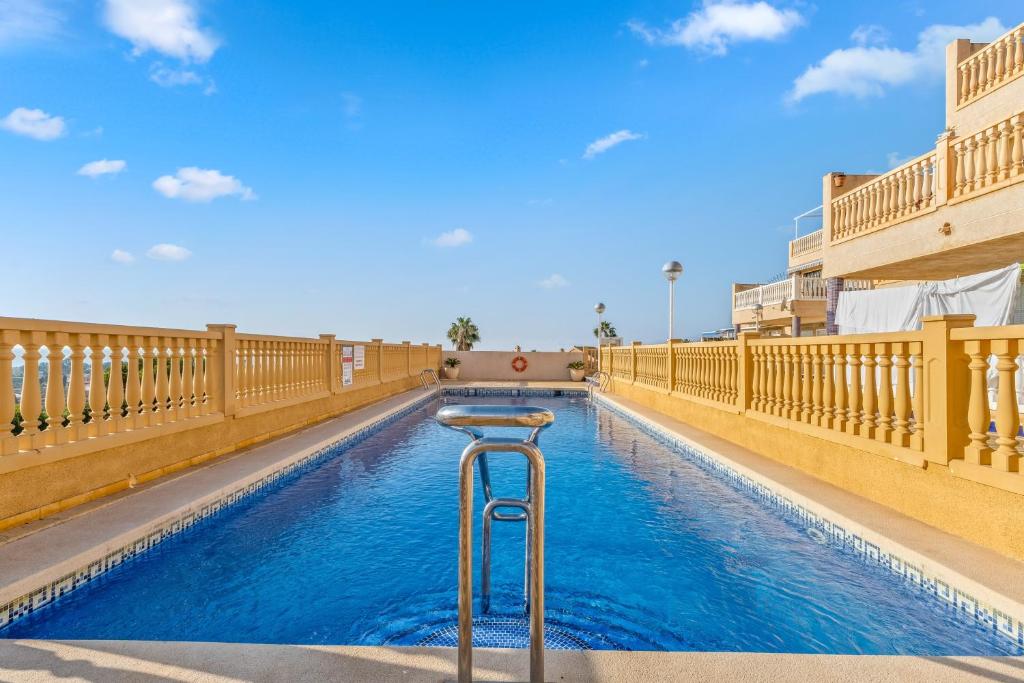 a swimming pool with blue water in a building at Apartment in Bolnuevo in Bolnuevo