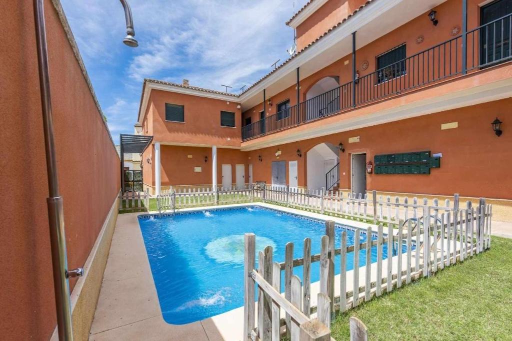 a swimming pool in the courtyard of a building at Apartamento Torero ii in Marchena