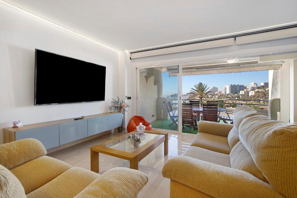 a living room with two couches and a flat screen tv at Luxury in Puerto Marina in Benalmádena