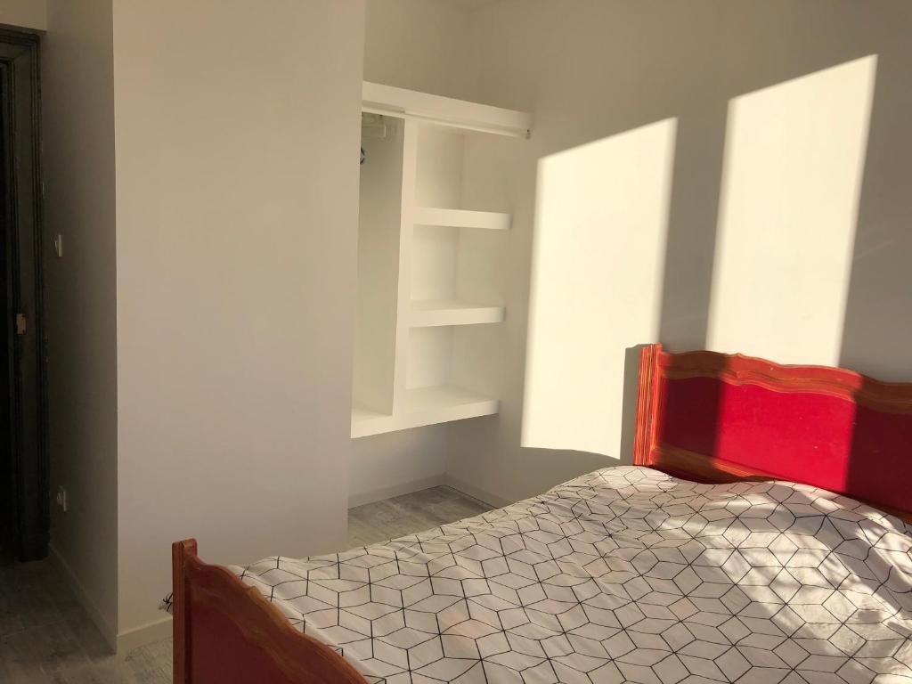 a bedroom with a bed and a book shelf at Famille in La Bourboule