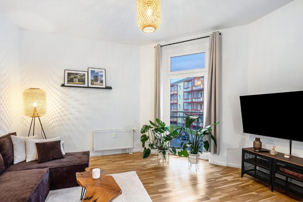 a living room with a couch and a flat screen tv at Ferienwohnung Agnes in Dessau