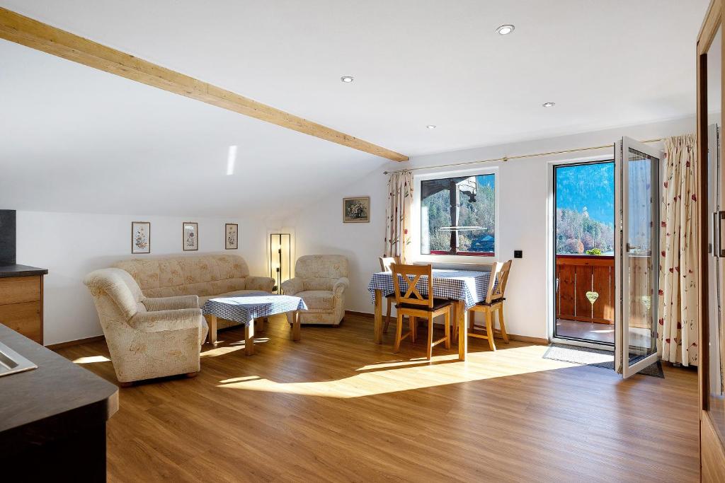 a living room with a couch and a table at Haus am See - Wohnung Jenner in Schönau am Königssee