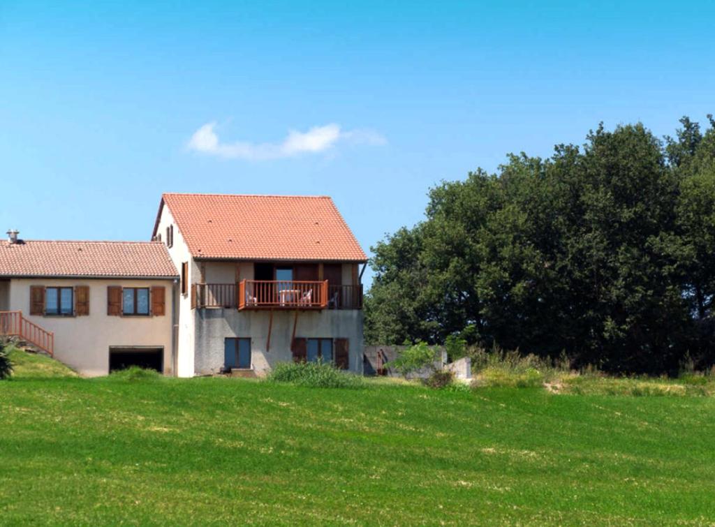 a house on a hill with a green field and trees at Gîte Télégraphe, Sonnay in Sonnay