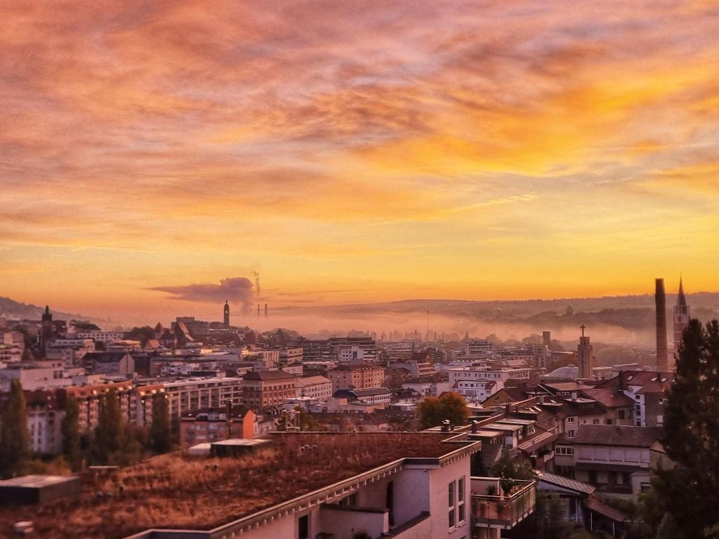 a view of a city at sunset at Ferienwohnung Goldstadtblick in Pforzheim