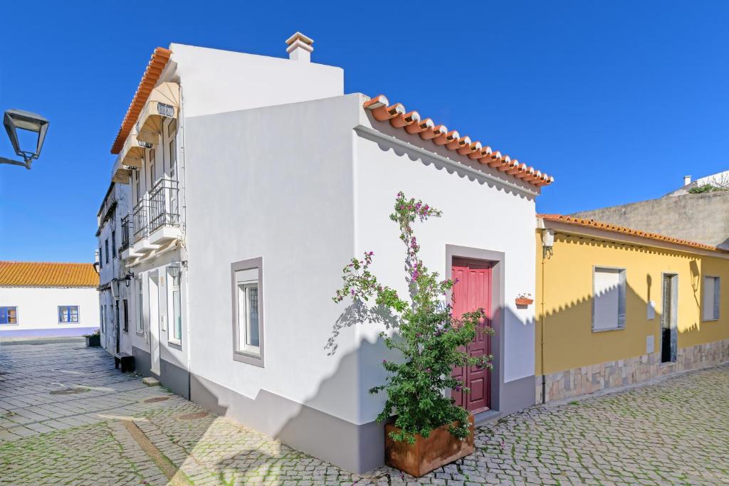 a row of colorful houses in a street at Casa Das Batatas in Odeceixe