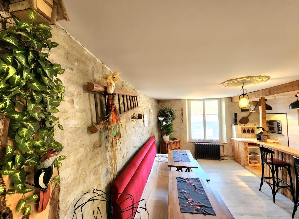 a living room with a plant on the wall at Gîte avec bar et four à pizza in Étreval