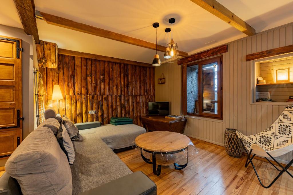 a living room with a couch and a table at Gite d'Orgeix - Ax-les-Thermes in Orgeix