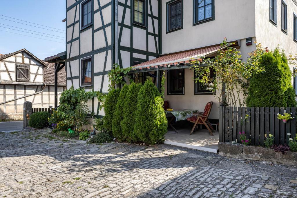 a house with a table in front of it at Dachwohnung Im Landhausstil in Meiningen