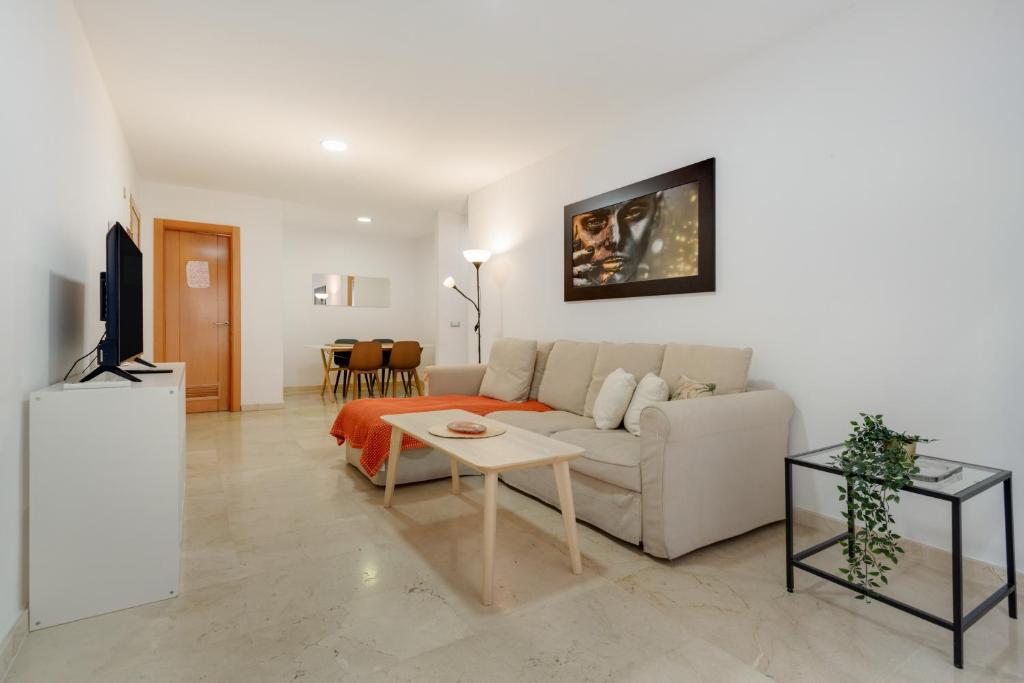 a living room with a couch and a table at Apartamento Centro con Aparcamiento in Santa Cruz de Tenerife