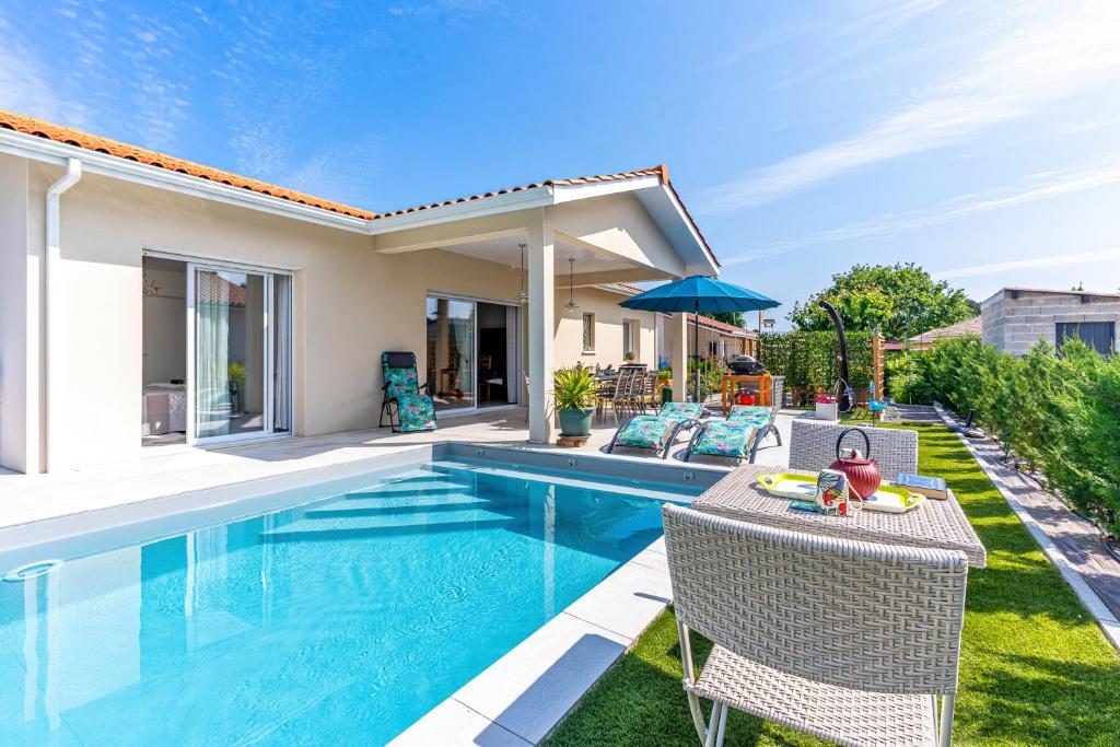 a swimming pool in the backyard of a villa at Villa du Lac - Gastes in Gastes