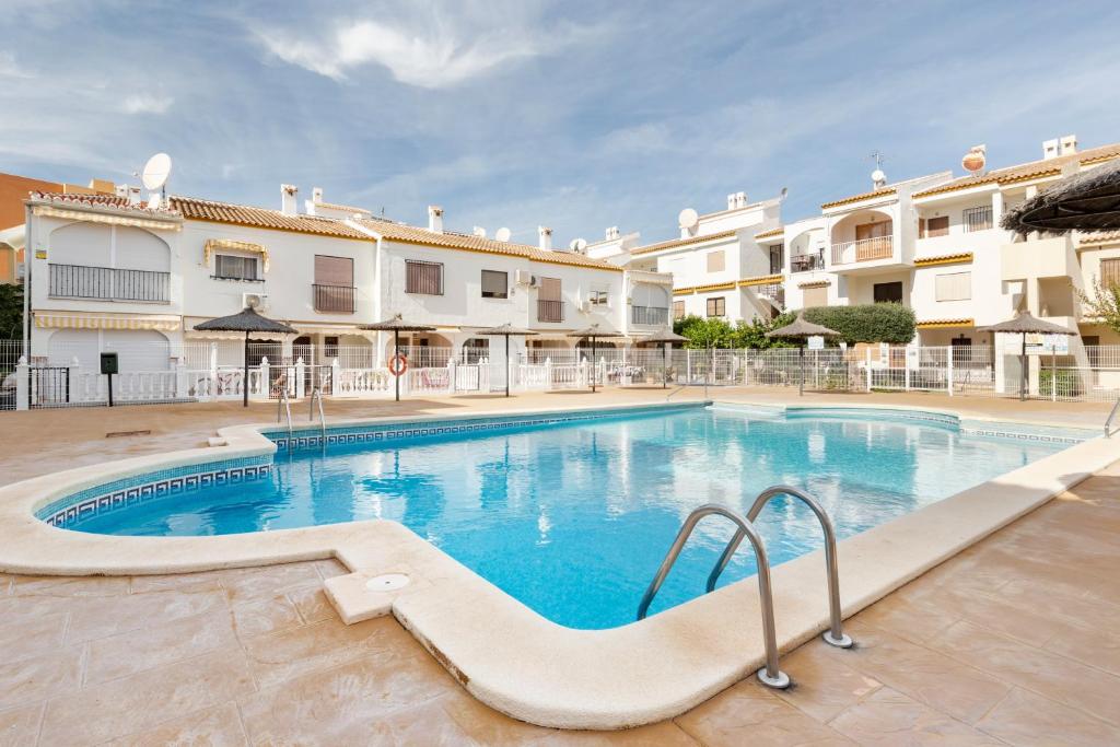 a large swimming pool in front of some buildings at Moreras in Puerto de Mazarrón