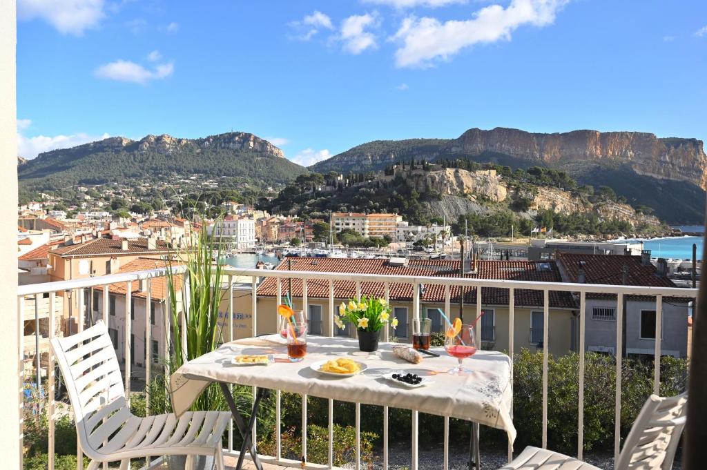 a table on a balcony with a view of a city at T2 Le Panorama in Cassis