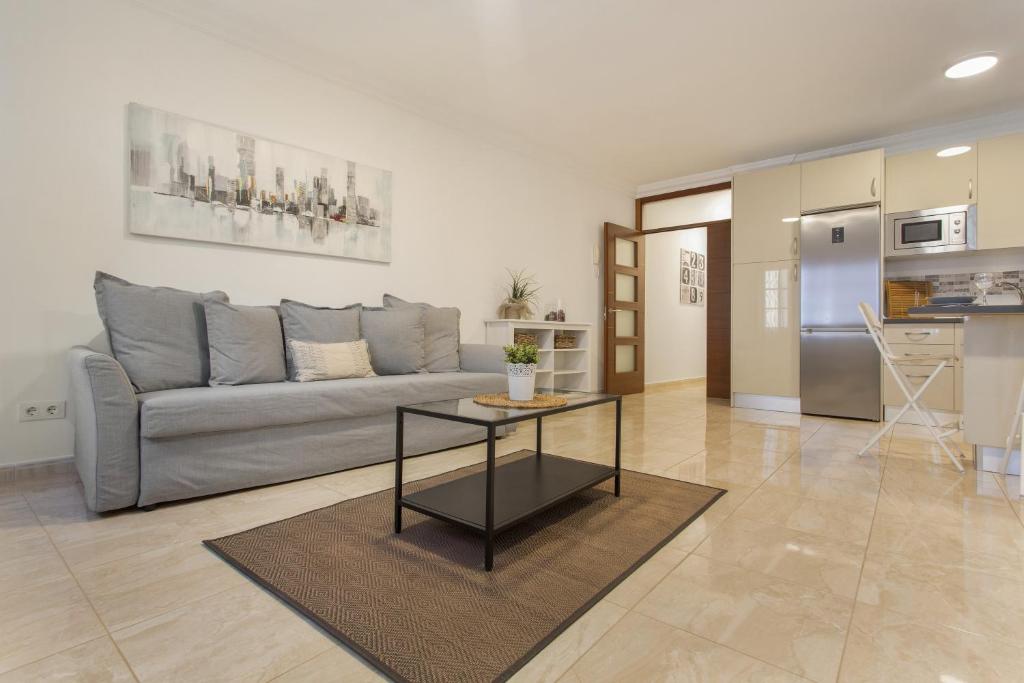 a living room with a couch and a table at Apartamento Rolycar 201 in Icod de los Vinos