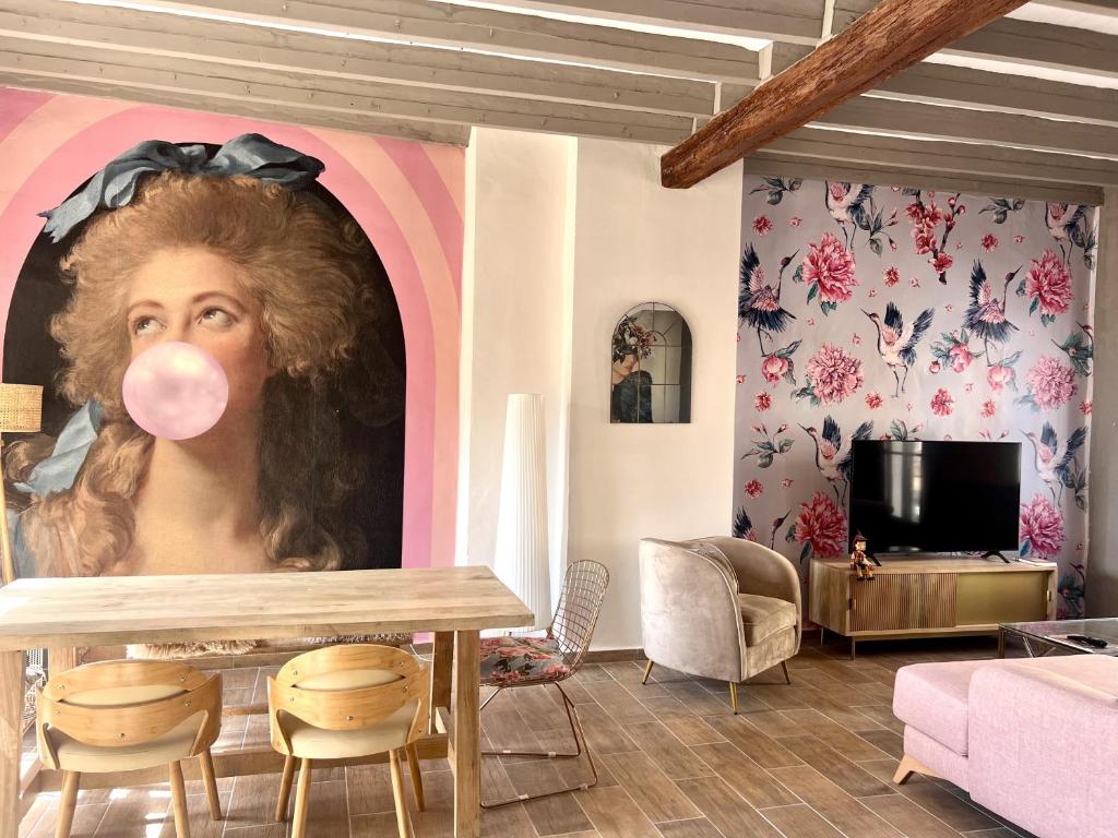 a room with a painting of a woman with a pink tongue at La Bonita de Pego in Pego