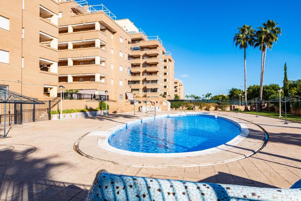 a swimming pool in front of a apartment building at Quintana's Home Oropesa Del Mar in El Borseral