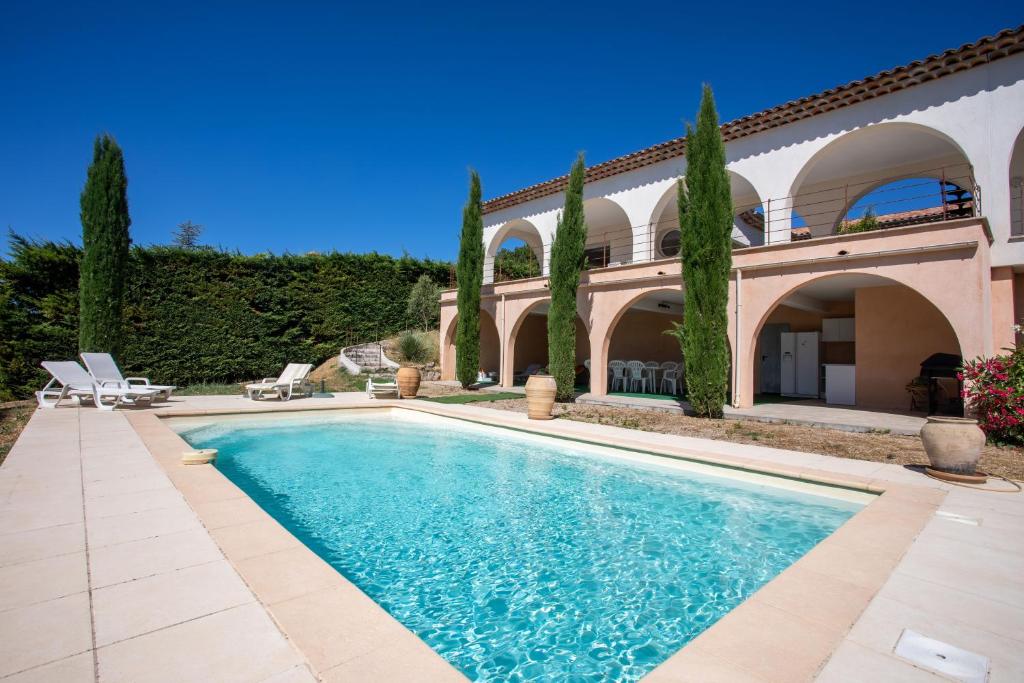 a swimming pool in front of a house at La Cabri 5 Chambres Piscine in Cabris