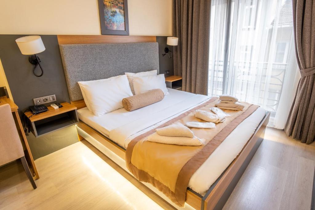 a hotel room with a bed with towels on it at Orange Hotel & Spa in Şişli
