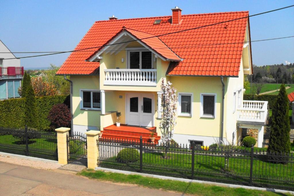 a white house with an orange roof at Ferienwohnung mit Terrasse, Garten in Gotha