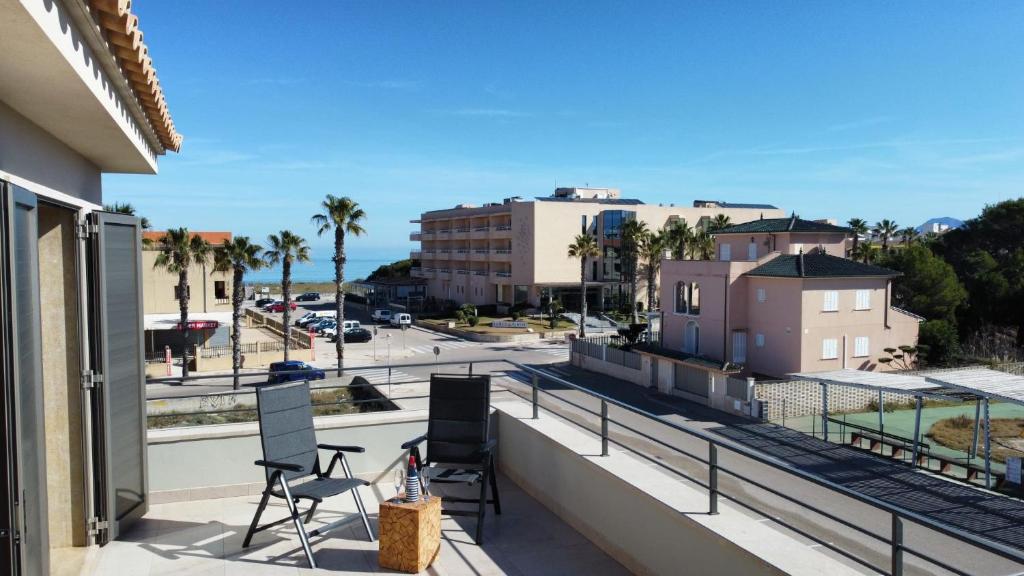 a balcony with chairs and a view of a street at Antonia in Can Picafort