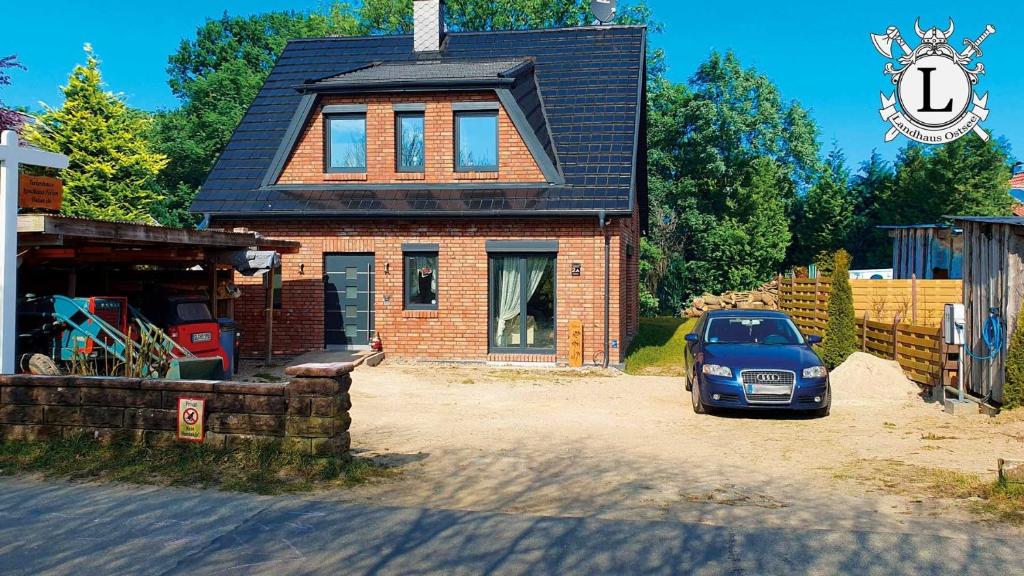 a car parked in front of a brick house at Landhaus Ferien Ostsee in Sterup