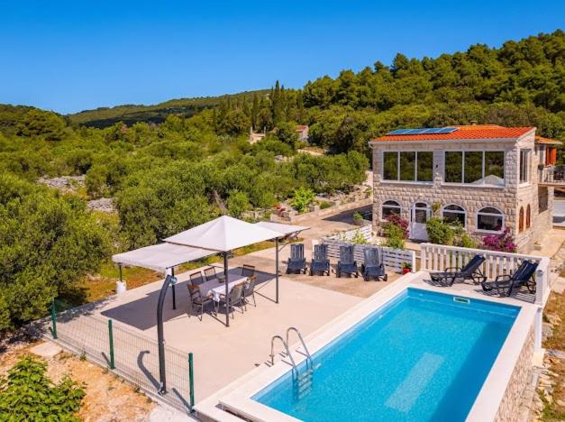 an aerial view of a house with a swimming pool at Stone oasis Marin in Žrnovo