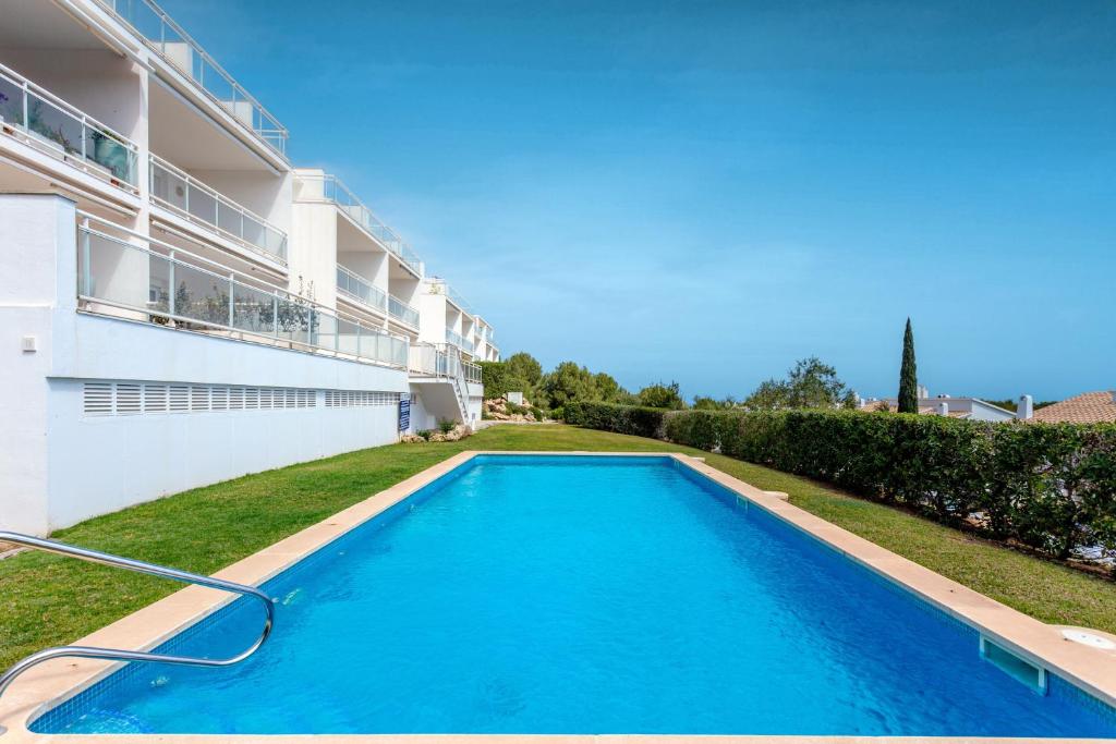 a swimming pool in the backyard of a building at Vista Faváritx in Es Mercadal