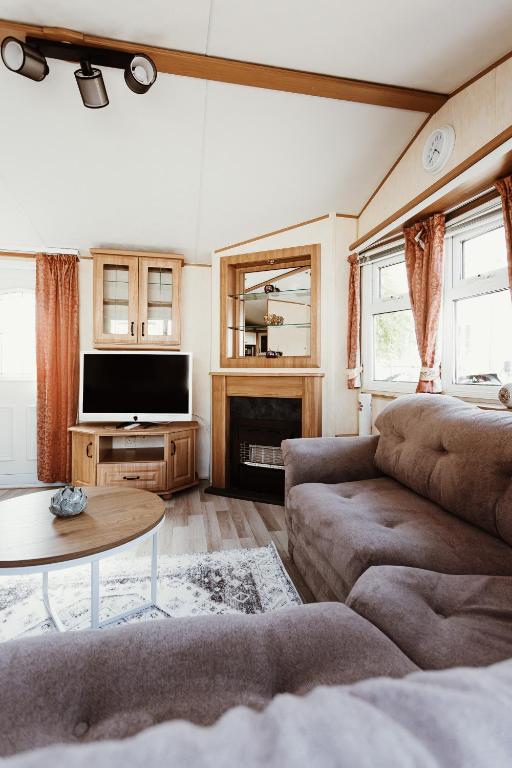 a living room with a couch and a tv at Villa Hexengericht in Thale