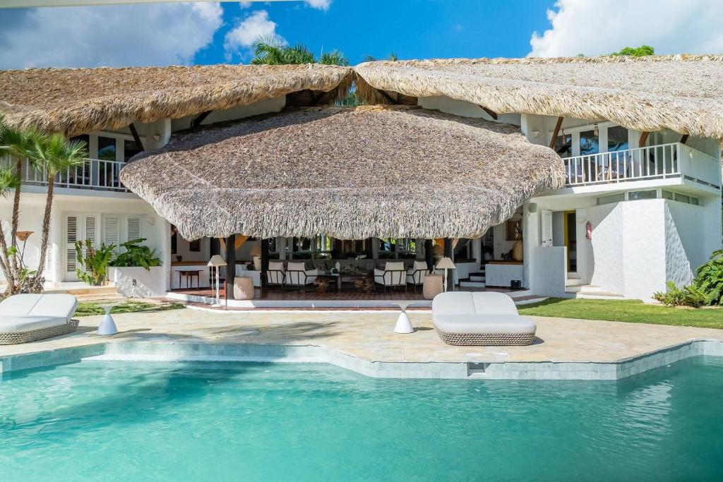 a villa with a swimming pool and a resort at Ocean View Villa, Pool, BBQ, Jacuzzi, Staff Incl in Cajuiles