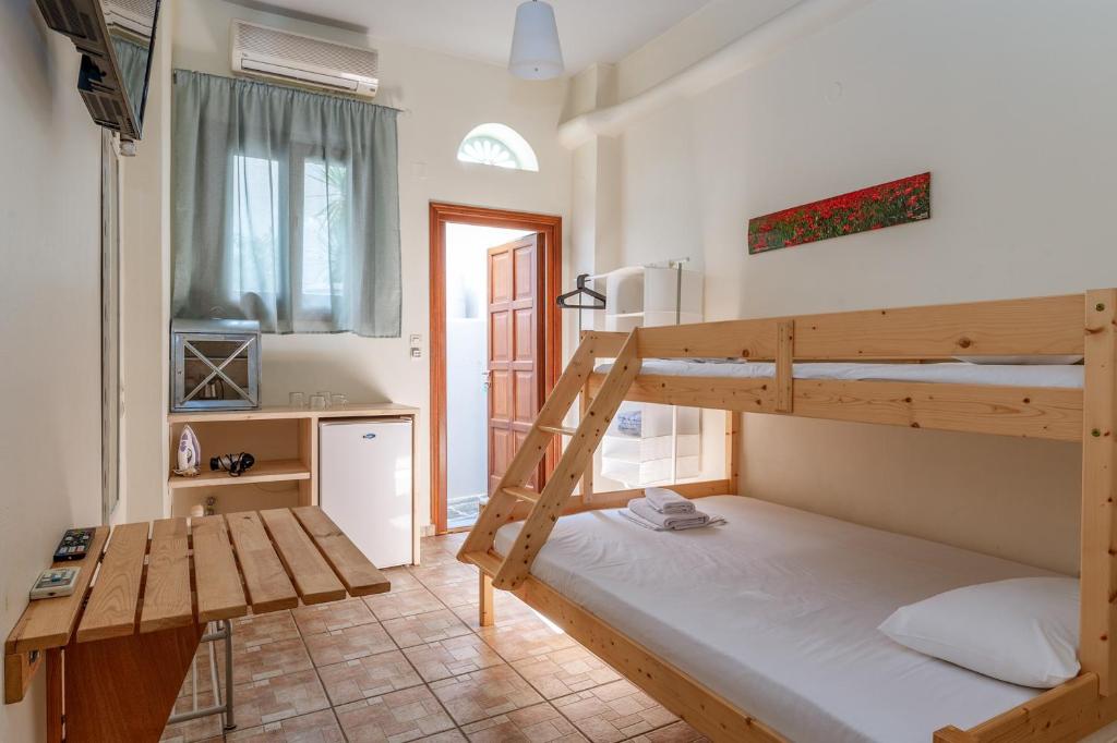 a room with two bunk beds and a kitchen at En Tino Basement 5 in Tinos