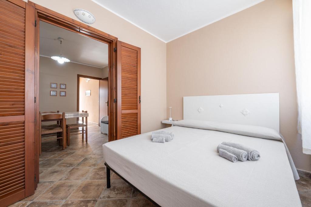 a bedroom with a bed with two towels on it at Le Sabbie Bianche in Calasetta