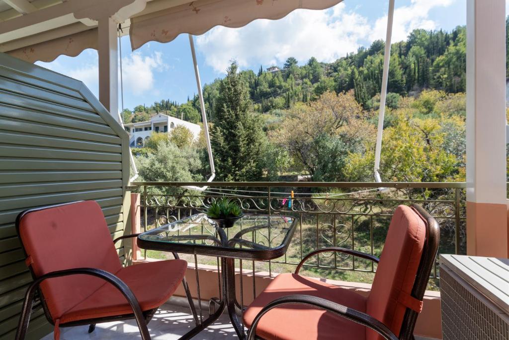 a balcony with chairs and a table with a view at Nontas Homes 37 in Kalamitsi