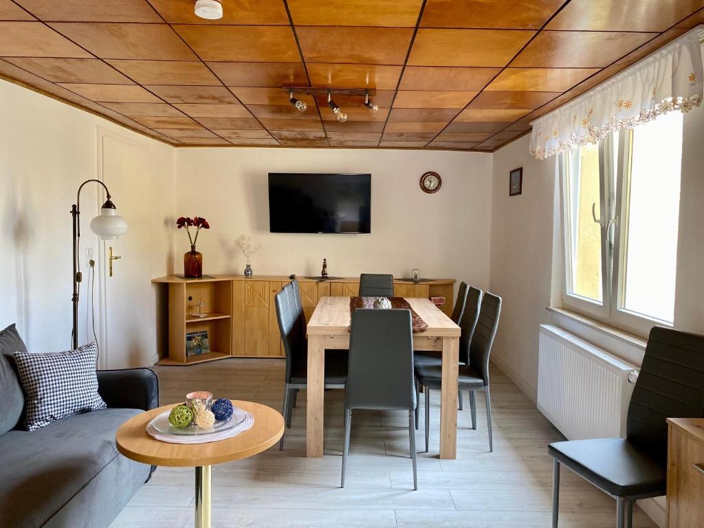a living room with a table and a dining room at Fischerhaus Zecherin in Zecherin