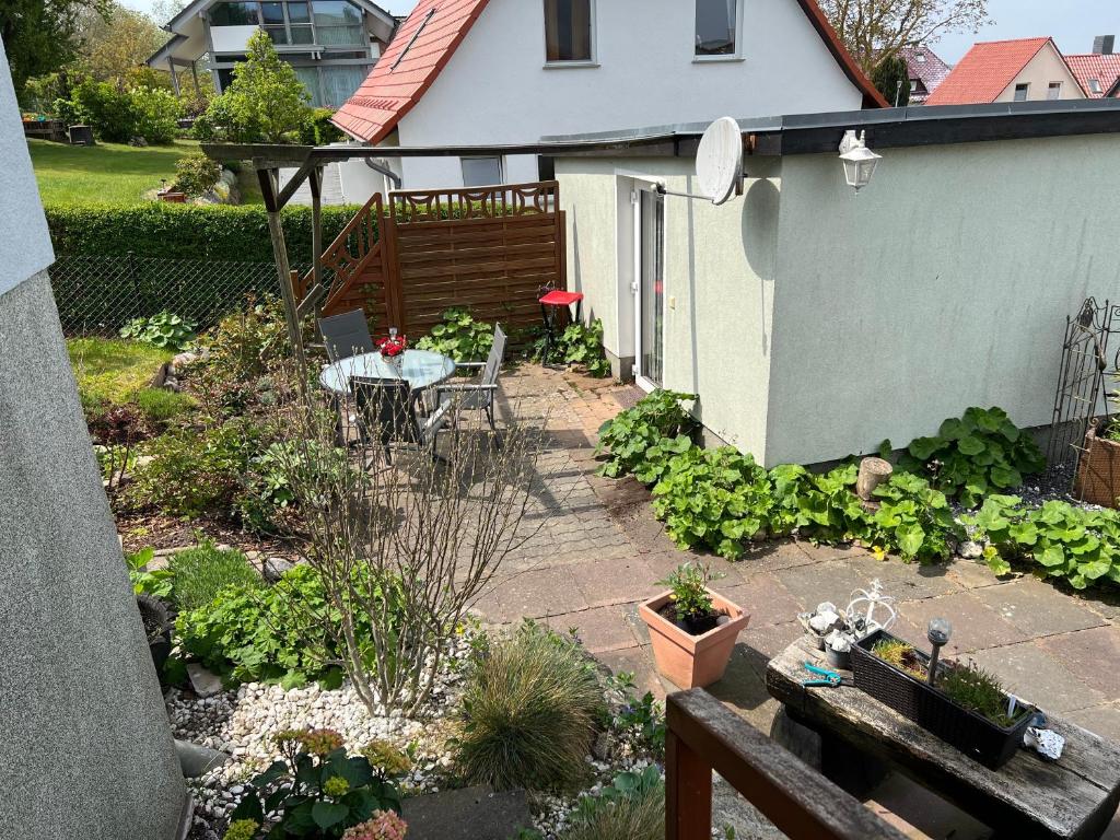 a garden with a table and chairs on a patio at Bungalow in Gager