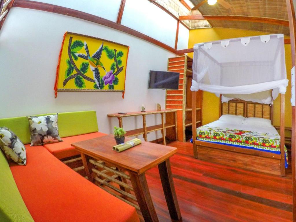 a living room with a couch and a bed at Villa 3 - High End Studio Apartment with kitchen, Playa Chiquita in Cocles