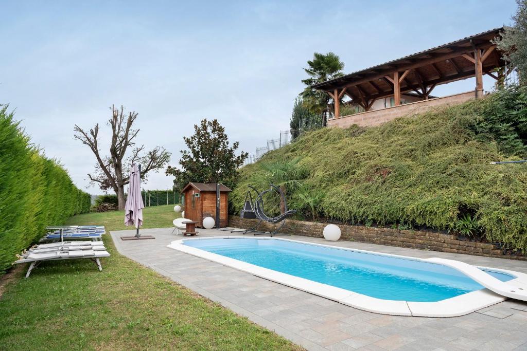 a swimming pool in the yard of a house at Tenuta Paradiso in Portacomaro