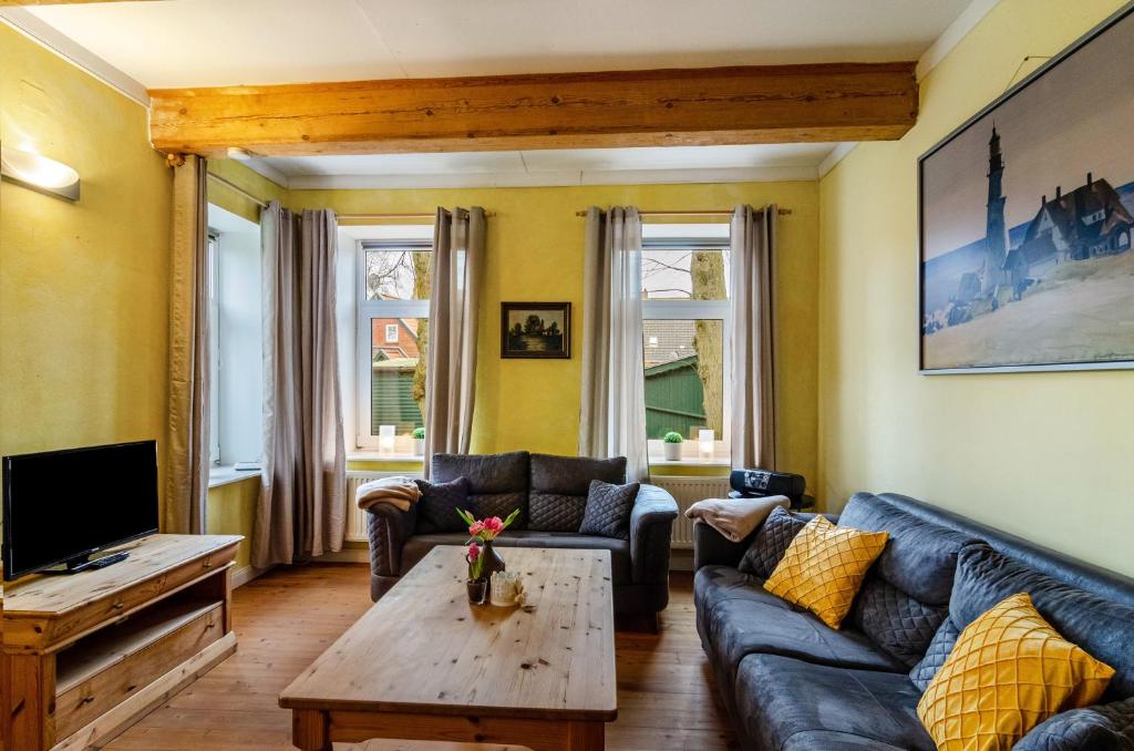 a living room with a couch and a coffee table at Gulfhof Oldersum Erdgeschoss in Moormerland
