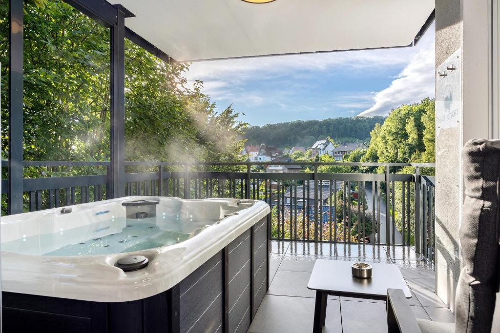 a hot tub on a balcony with a view at Egge Resort 7a mit Whirpool u Sauna in Altenbeken