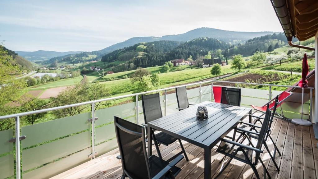 a table and chairs on a balcony with a view at Vorderbühlhof in Oppenau