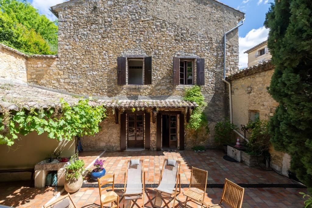 a patio with chairs and a table in front of a building at Le Lion d'Or in Lagorce