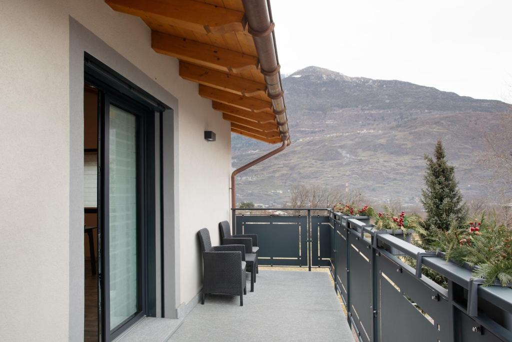 a balcony with chairs and a view of a mountain at Appartamento Alice in Caiolo