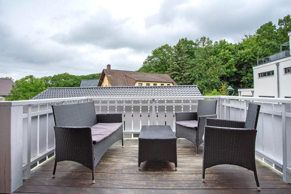 a group of chairs and a table on a deck at Haus Albatros Wohnung 4 in Koserow