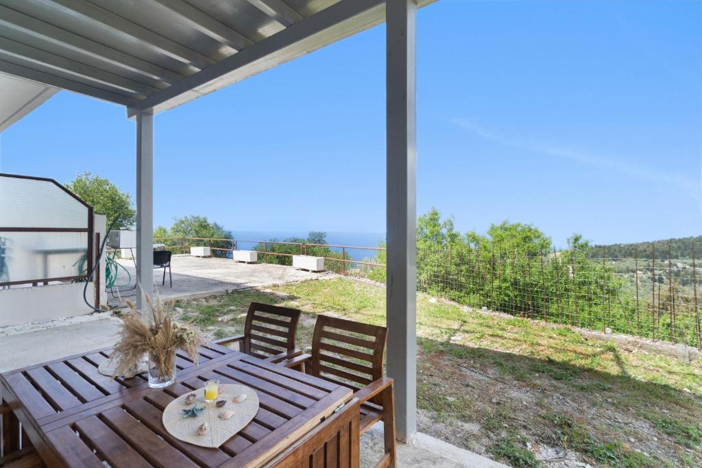 a patio with a table and a view of the ocean at Villa Andreas in Athani