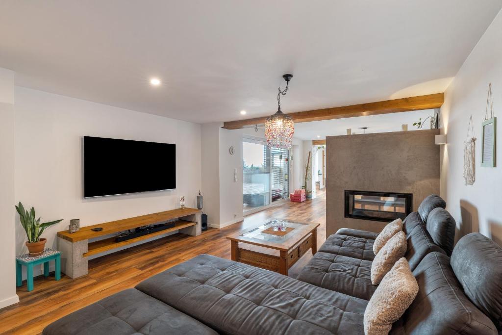 a living room with a couch and a flat screen tv at Haus Elisabeth in Lauf