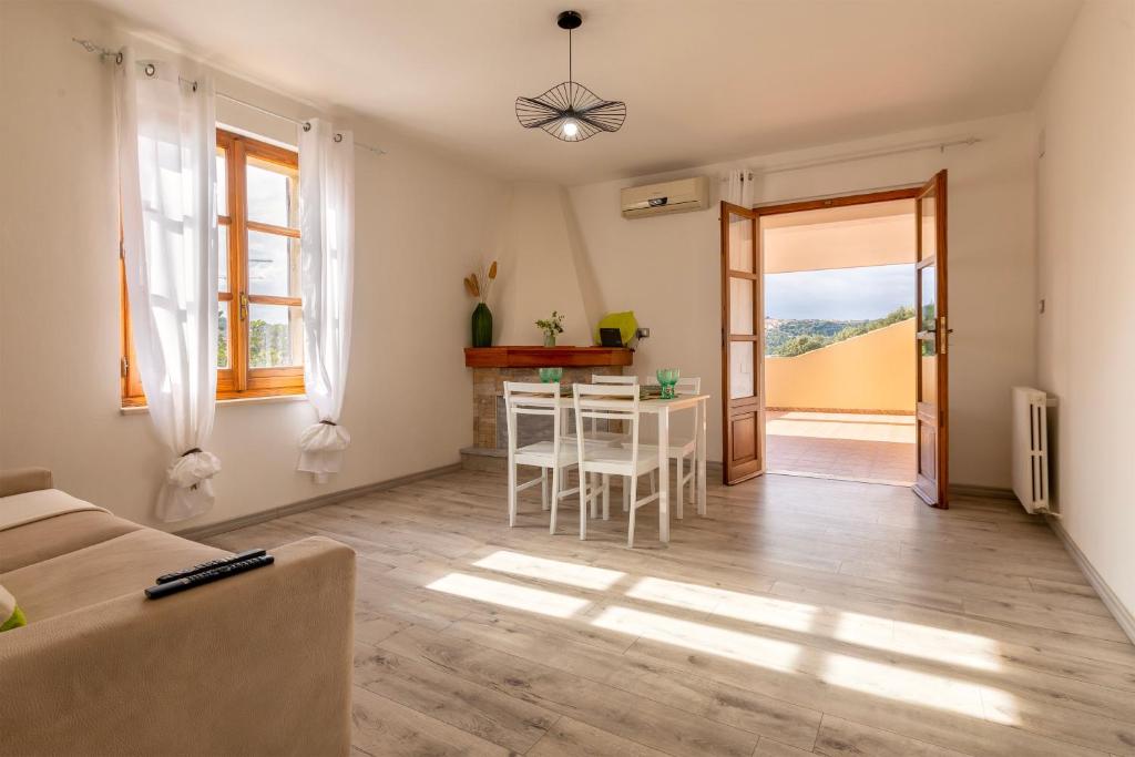 a living room with a table and a dining room at Casa Belvedere in Codrongianos